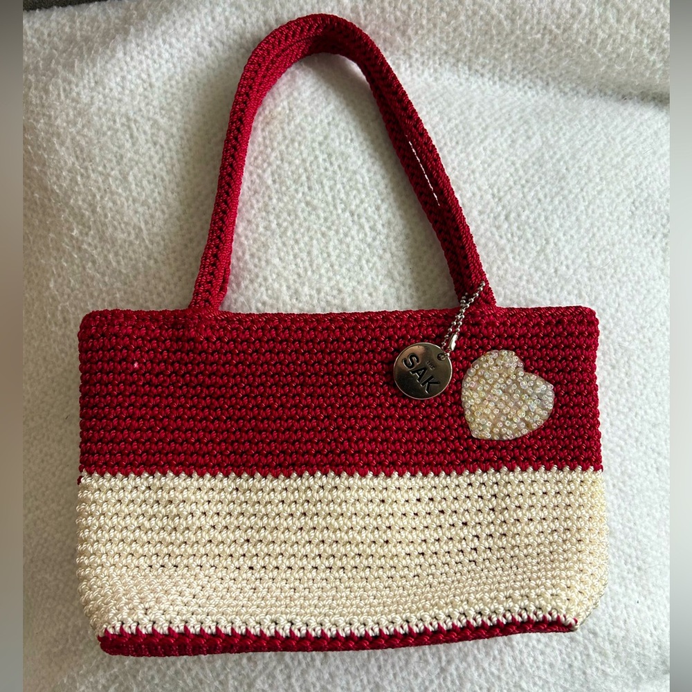 “the sak” red and white crochet hand bag with white beading shaped like a heart
